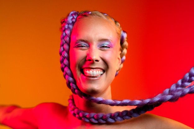 Norwegian artist and songwriter Mathilde SPZ, with bright braided hair and makeup, who released the new single 'Don’t Quit' with Ayko and George.